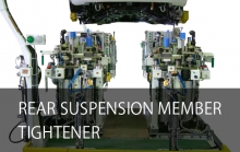 Rear suspension member tightener